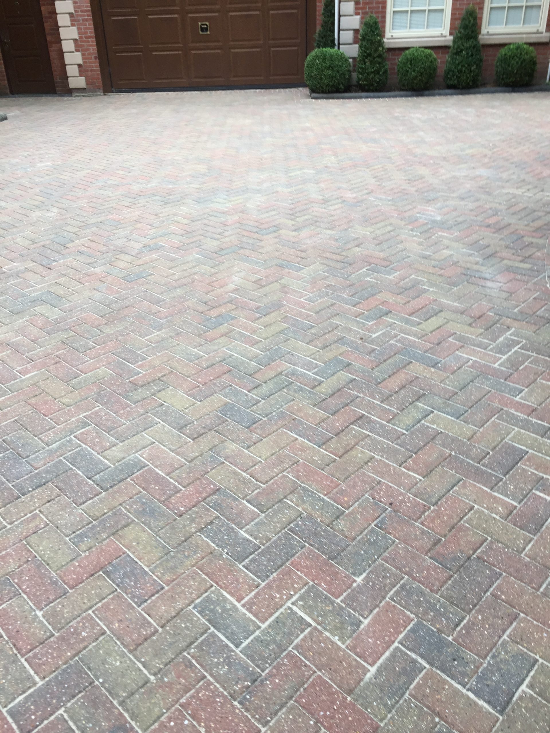 Clean herringbone block-paved driveway after cleaning