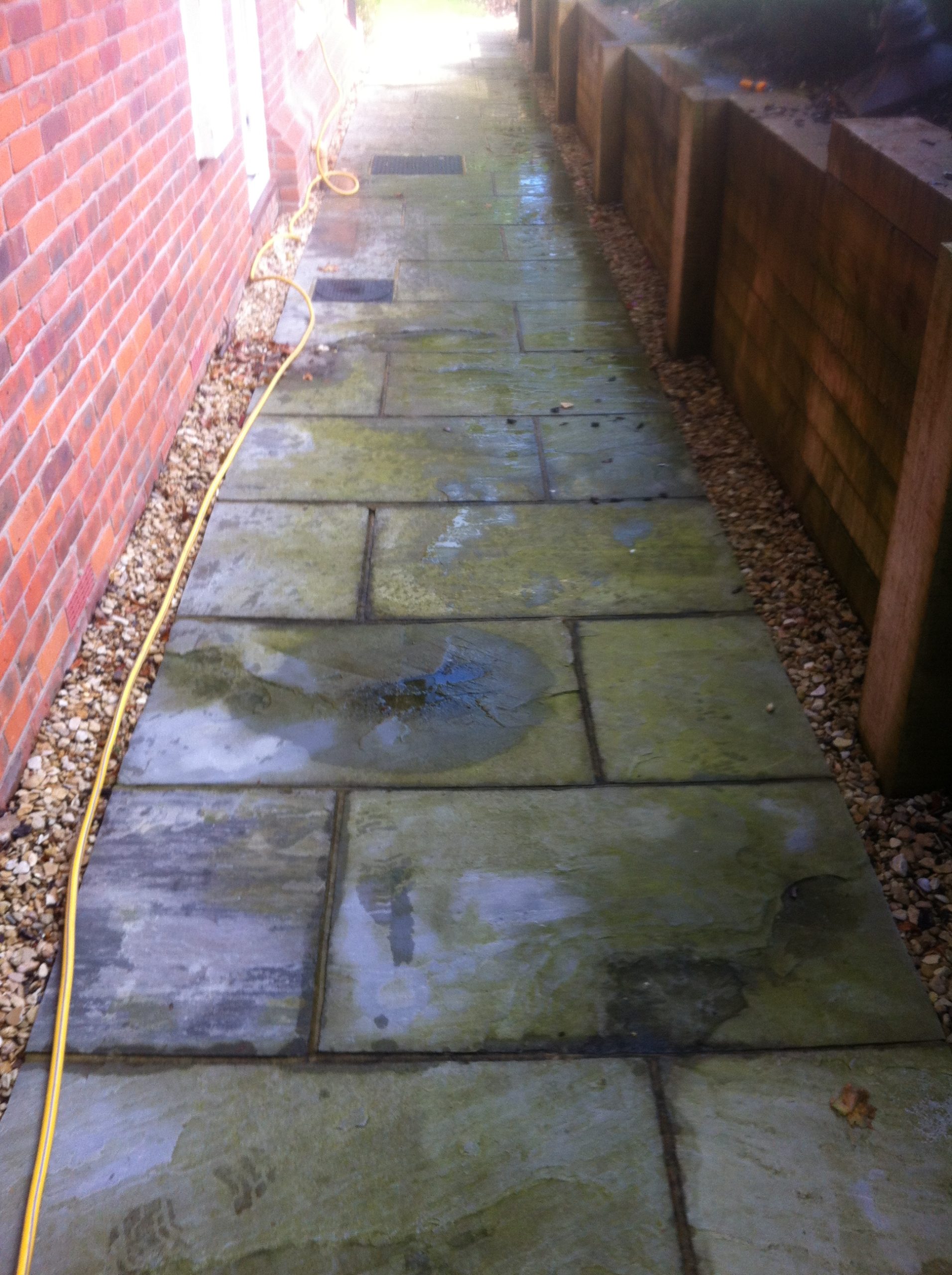 Dirty patio garden wall before cleaning