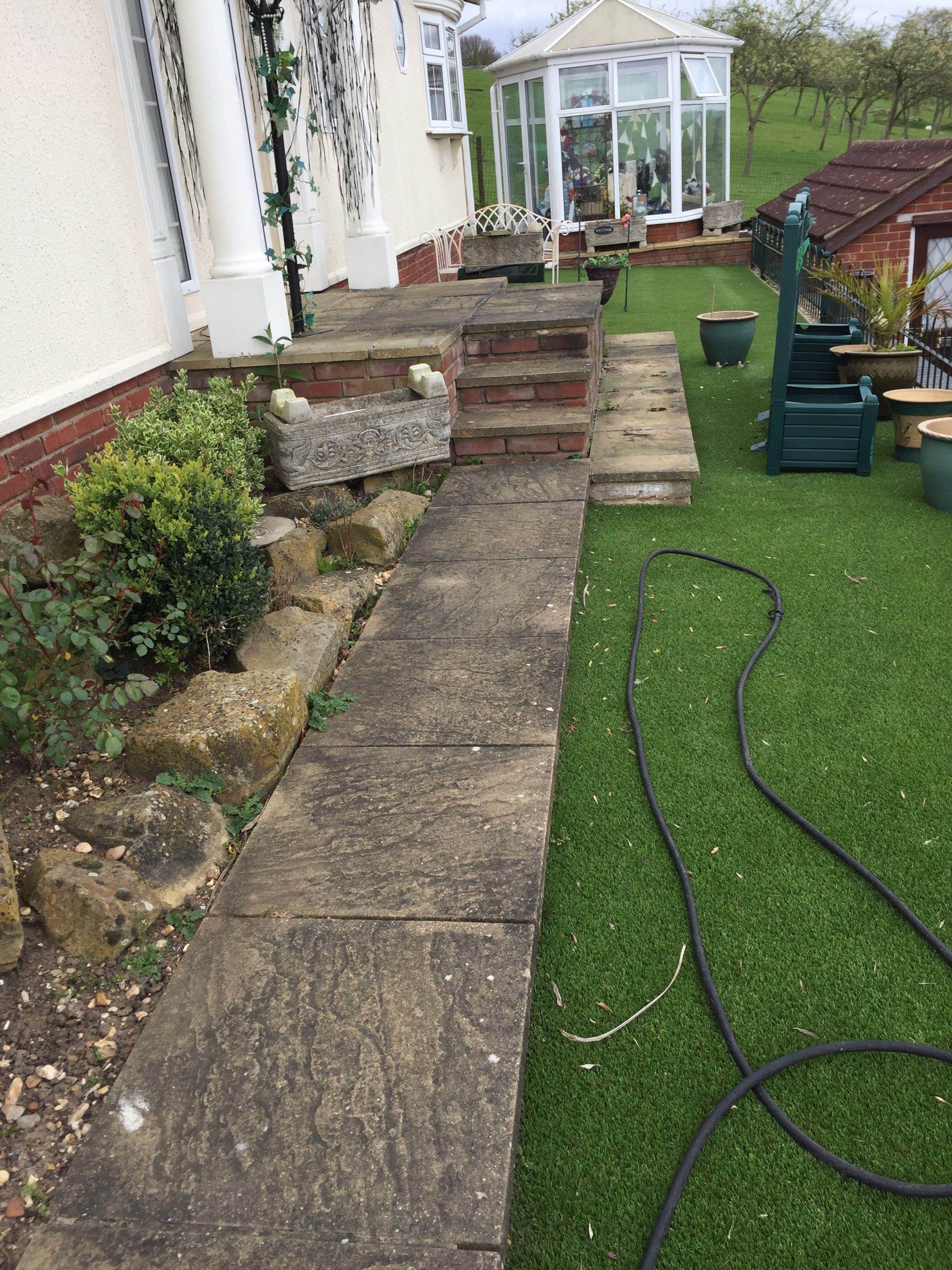 Dirty patio garden wall before cleaning