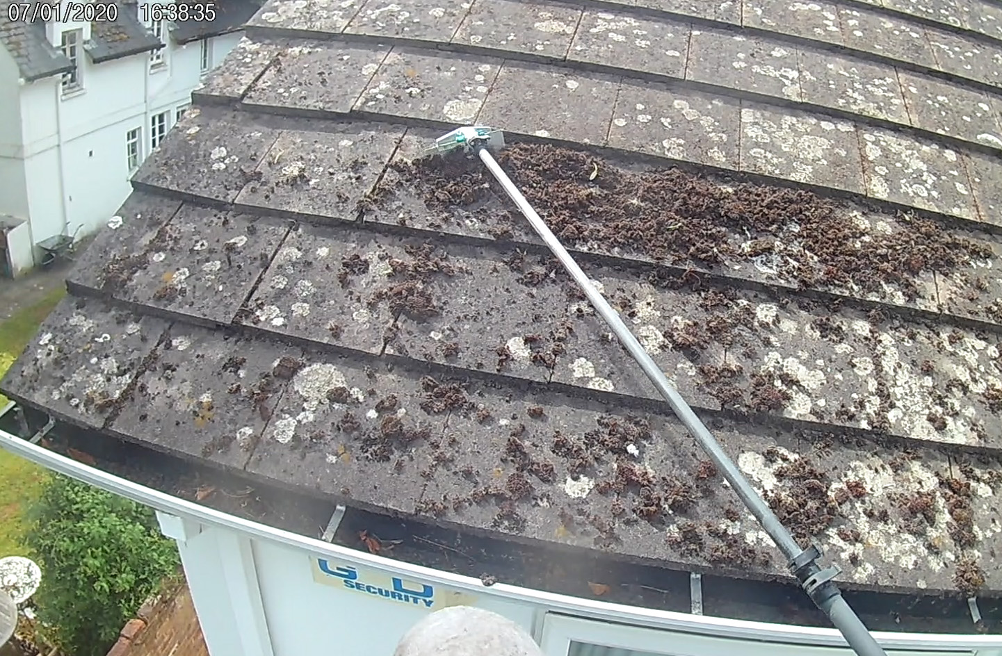 Moss and lichen being removed from a roof in Maidenhead